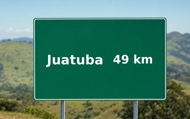 Placa de estrada indicando Juatuba a 49 km